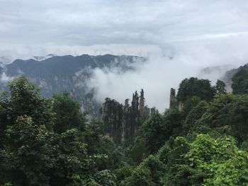 Scenic view of mountain against cloudy sky