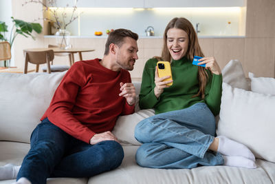 Happy family sitting on bed at home