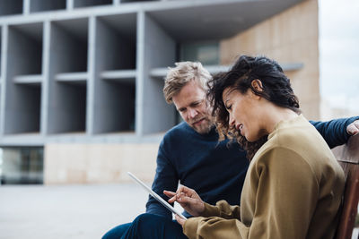 Business colleagues having discussion over tablet pc