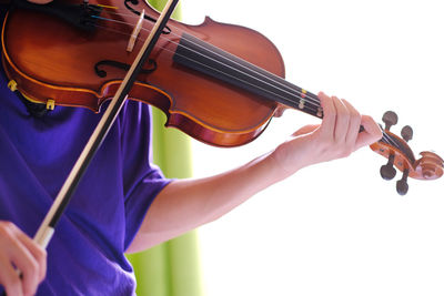 Midsection of man playing guitar