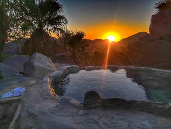 Scenic view of rocks against sky during sunset