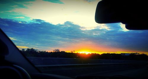 Car on road at sunset