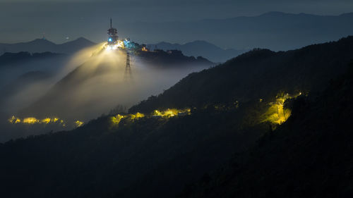 Scenic view of illuminated mountain against sky at night