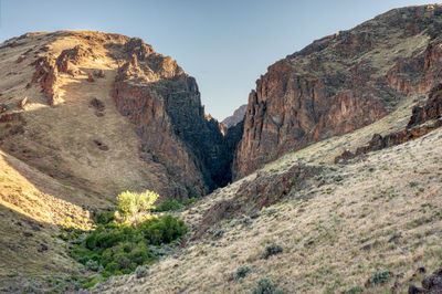 Scenic view of rocky mountains against clear sky