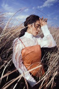 Woman on field against sky