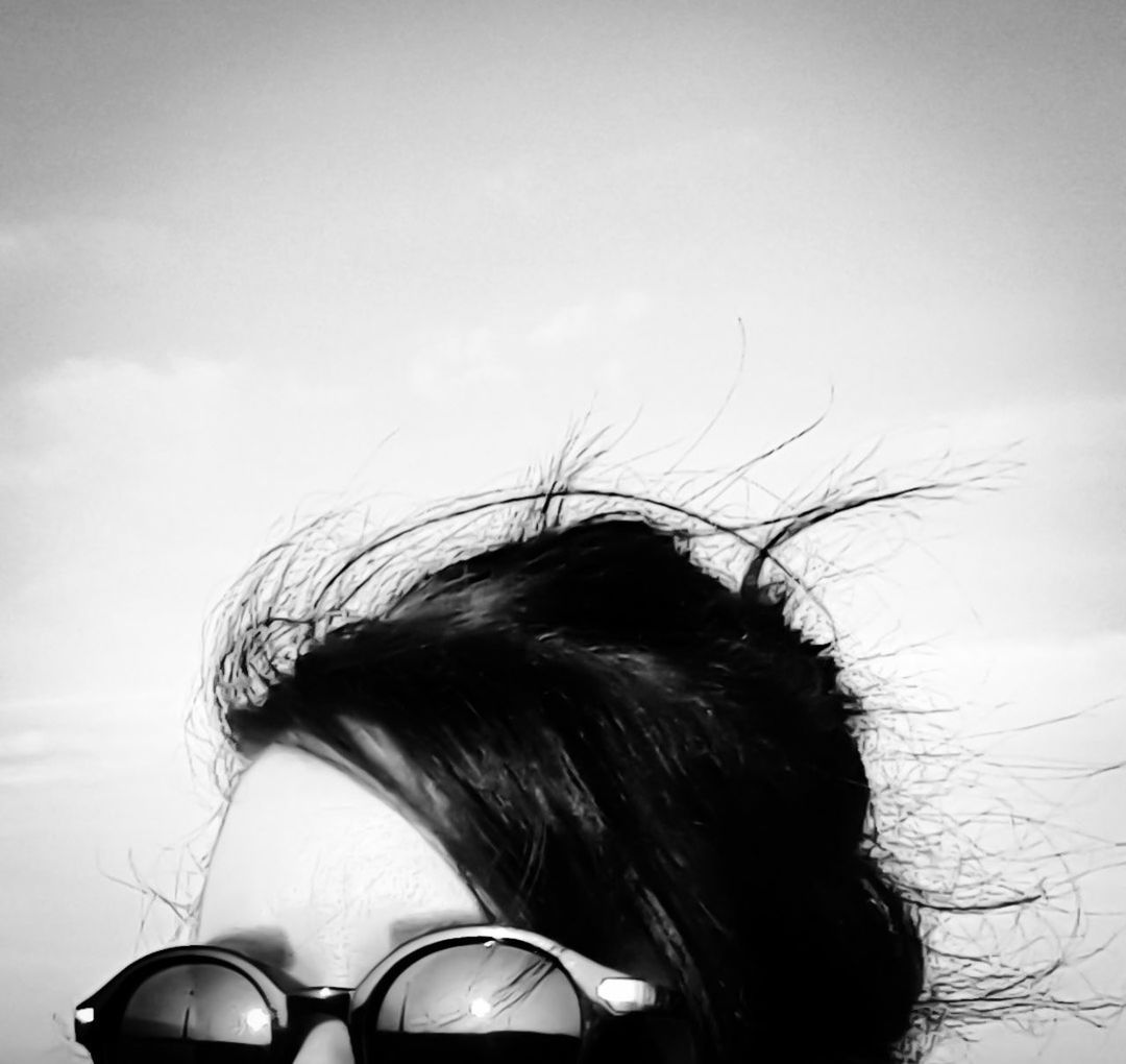 sunglasses, real people, one person, headshot, sky, outdoors, lifestyles, day, close-up, young adult, people