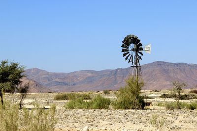 Scenic view of desert against clear blue sky