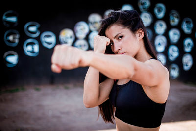 Portrait of athlete showing fist at gym