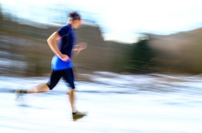 Side view of man running