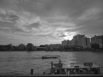 City by river against sky