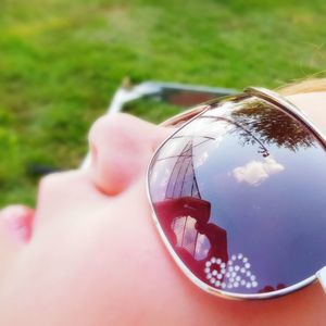 Close-up of woman hand holding sunglasses