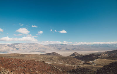 Scenic view of desert against blue sky