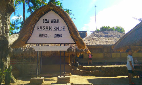 Information sign on building against sky