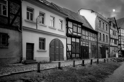 Exterior of old building by street against sky