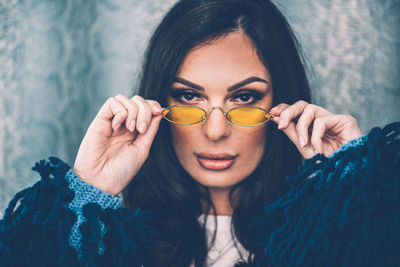 Close-up portrait of beautiful woman wearing sunglasses