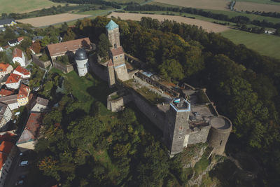 High angle view of houses amidst trees and buildings