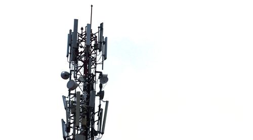 Low angle view of communications tower against sky