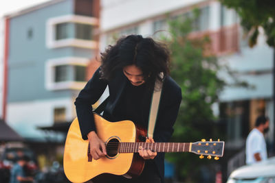 Young woman playing guitar