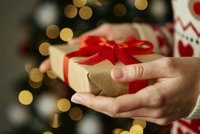 Cropped hand of woman holding gift box