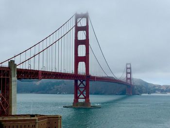 Golden gate bridge over bay against sky