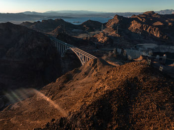 Bridge over mountains against sky