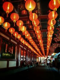Illuminated lamp post at night