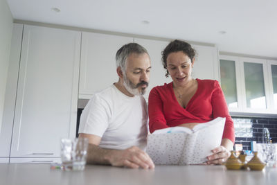 Man and woman sitting on table