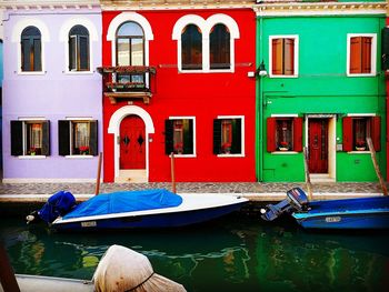 Boat moored in canal by building