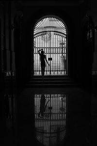 Silhouette man walking in corridor of building