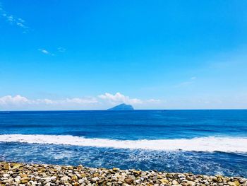 Scenic view of sea against blue sky