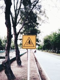 Close-up of information sign against trees