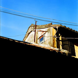 Low angle view of house against clear blue sky