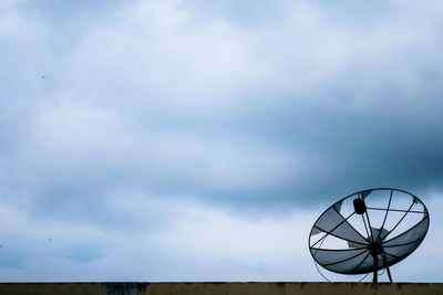 Low angle view of ferris wheel against sky