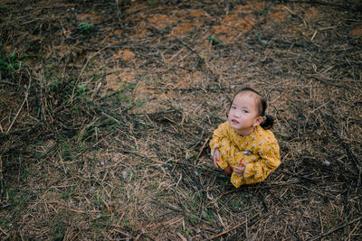 High angle view of child looking away on field