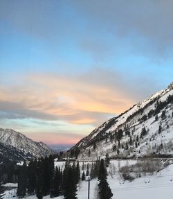 Scenic view of snow covered mountains against sky during sunset