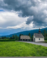 Built structure on field against sky