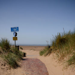 Scenic view of beach against clear blue sky