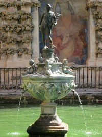 Statue of fountain in front of building