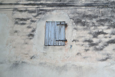 Low angle view of window on old building