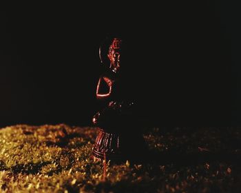 High angle view of woman standing on field at night