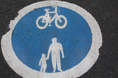 Close-up of bicycle sign on road