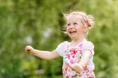 Happy laughing baby girl running in a clover fielda happy laughing baby is running around the park 