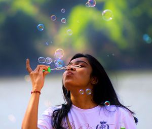 Portrait of woman looking at bubbles