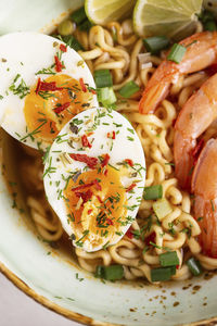 Bowl of ramen soup with shrimps and eggs