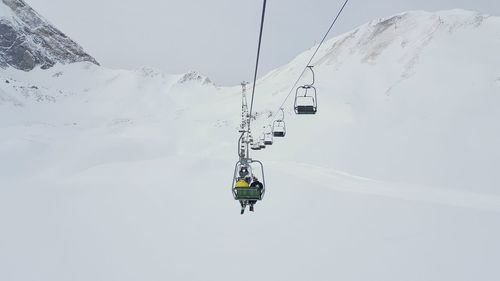 Overhead cable cars over snowy field during winter