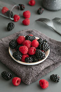 Berry fruits in bowl on table