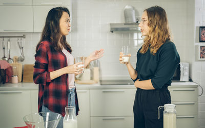 Young woman drinking glass with beer at home