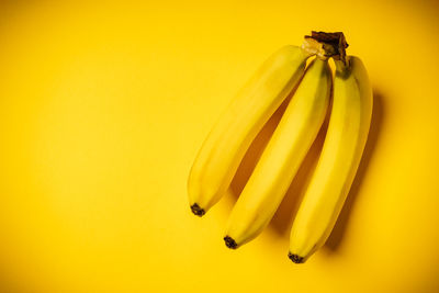 Close-up of bananas on yellow background