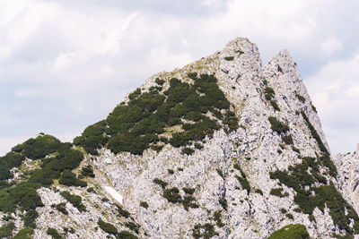 Low angle view of rock formations against sky