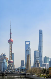 Buildings in city against clear sky